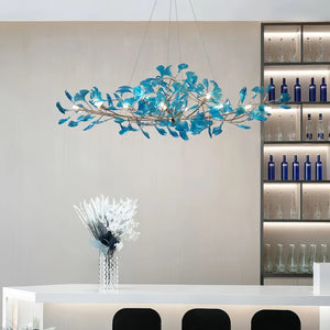 Blue glass ginkgo leaf chandelier in modern interior