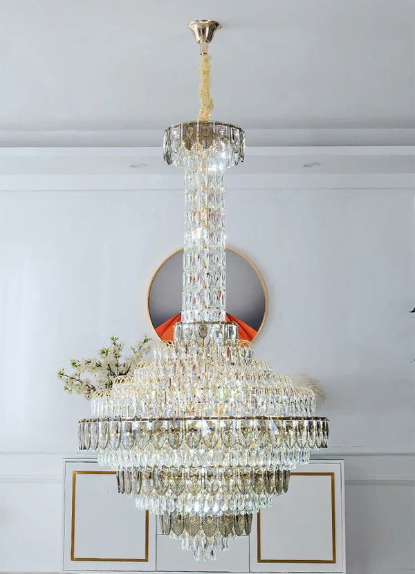 Oversized chandelier creating a dramatic staircase lighting effect