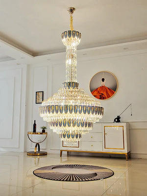 Chandelier casting warm light over polished marble stairs