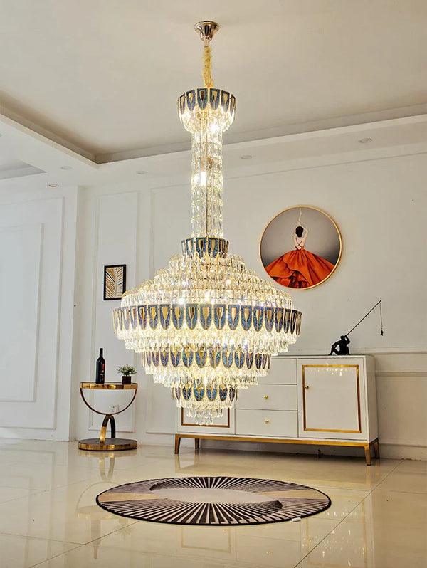 Chandelier casting warm light over polished marble stairs