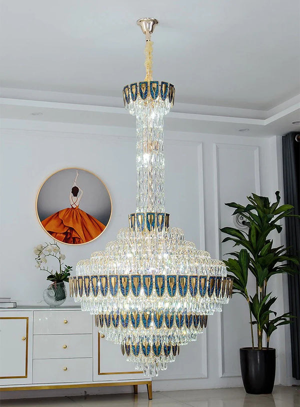 Luxury chandelier installation in high-ceiling entrance area