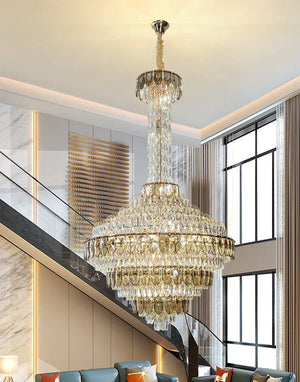 Luxury chandelier installation in high-ceiling entrance area