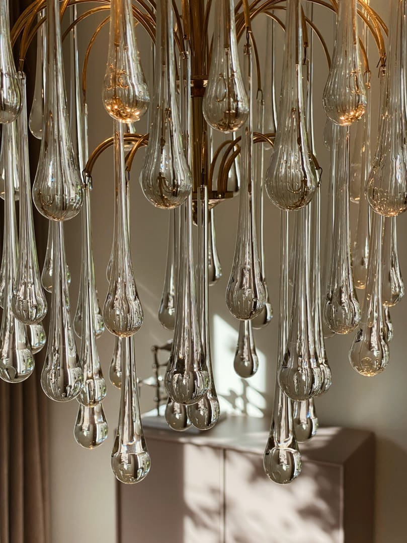 Dining room with a round table, chair, and decorative chandelier.